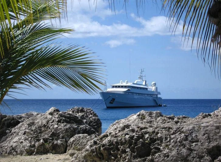 a white boat on a beach aboard ADAMAS V Yacht for Sale