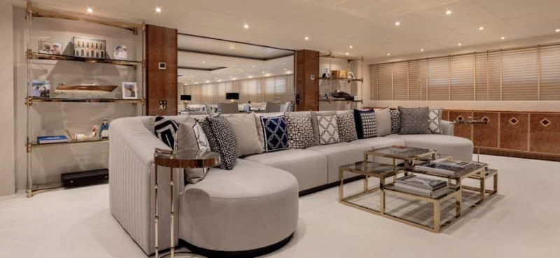 a large living room with a white couch and a coffee table aboard ADAMAS V Yacht for Sale