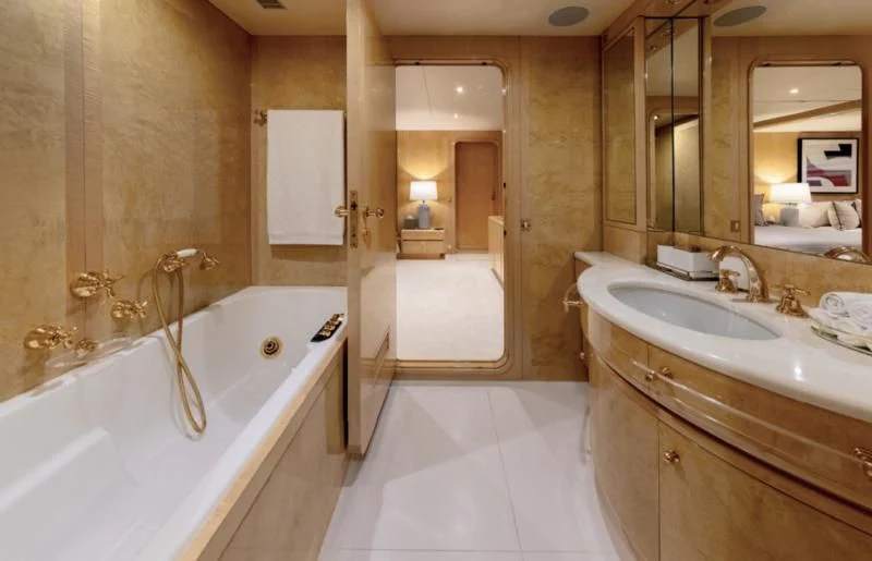 a bathroom with a tub sink and a sink aboard ADAMAS V Yacht for Sale