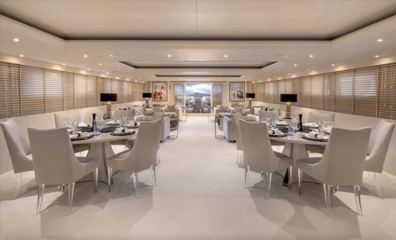 a large room with tables and chairs aboard ADAMAS V Yacht for Sale