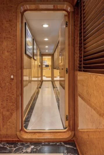 a hallway with a glass door aboard ADAMAS V Yacht for Sale