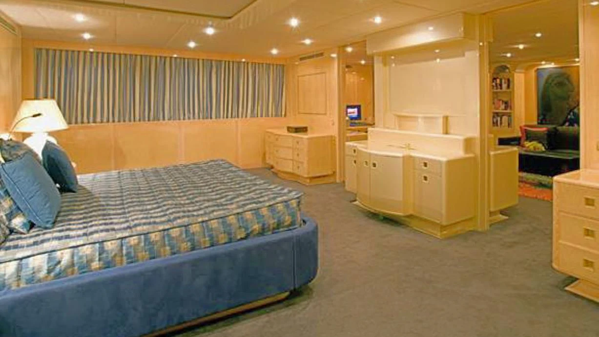 a bedroom with a bed and a desk aboard ADAMAS V Yacht for Sale