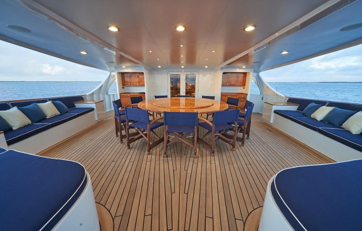 a large room with a table and chairs aboard ASTERIA Yacht for Charter