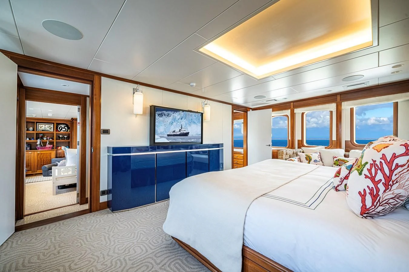a room with a bed and a television aboard ASTERIA Yacht for Charter