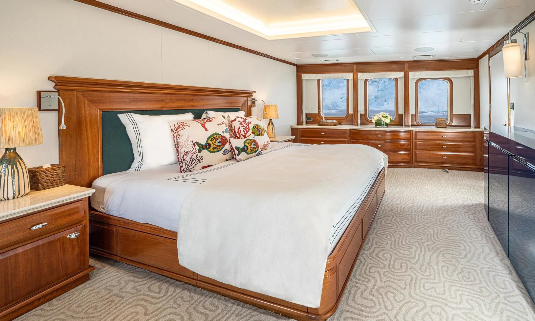 a bedroom with a bed and a desk aboard ASTERIA Yacht for Charter