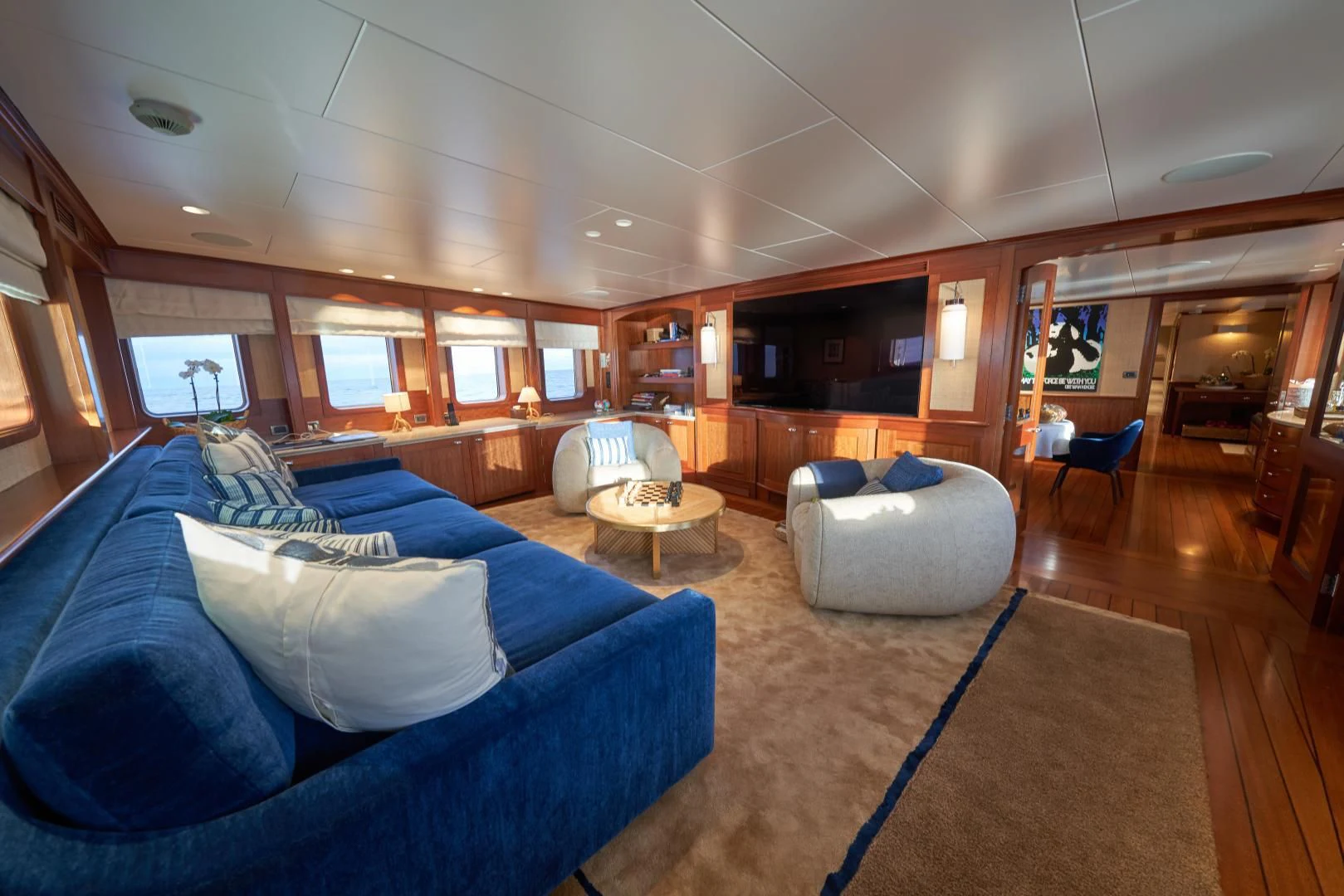 a living room with a blue couch aboard ASTERIA Yacht for Charter