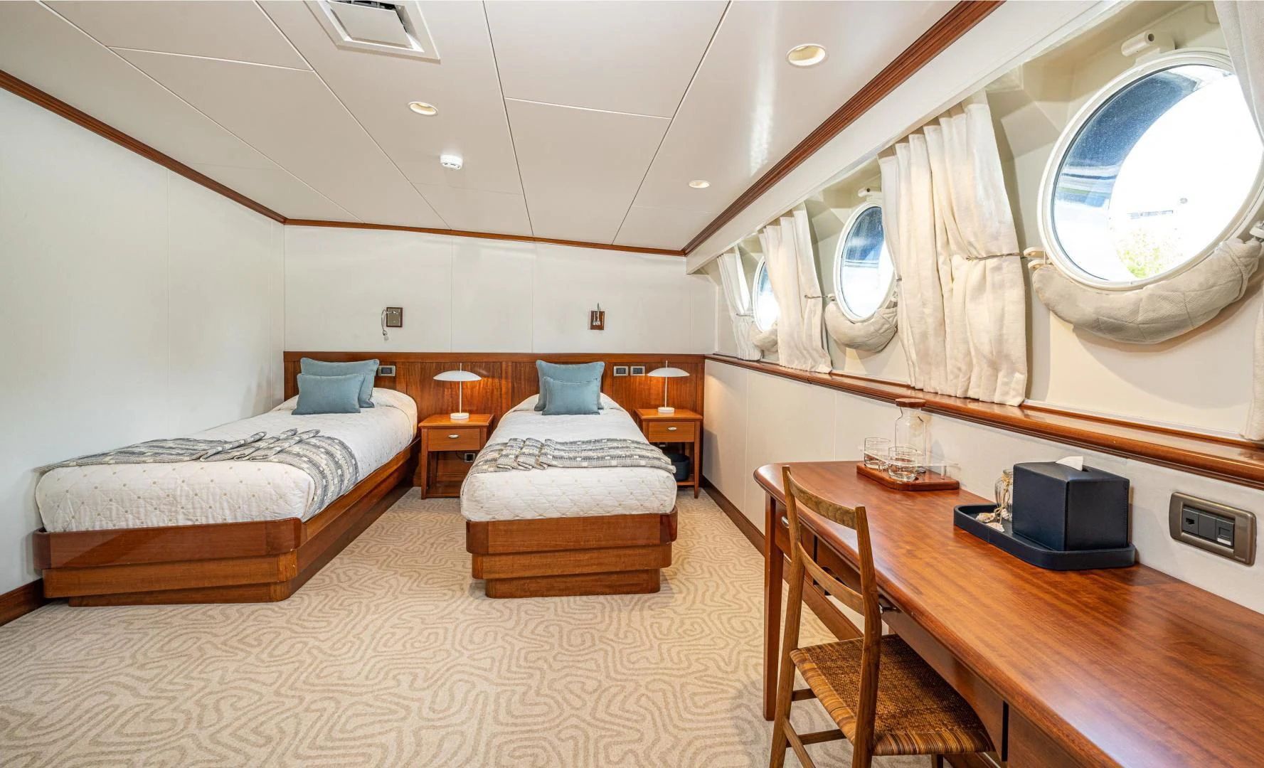 a room with a bed and a desk aboard ASTERIA Yacht for Charter
