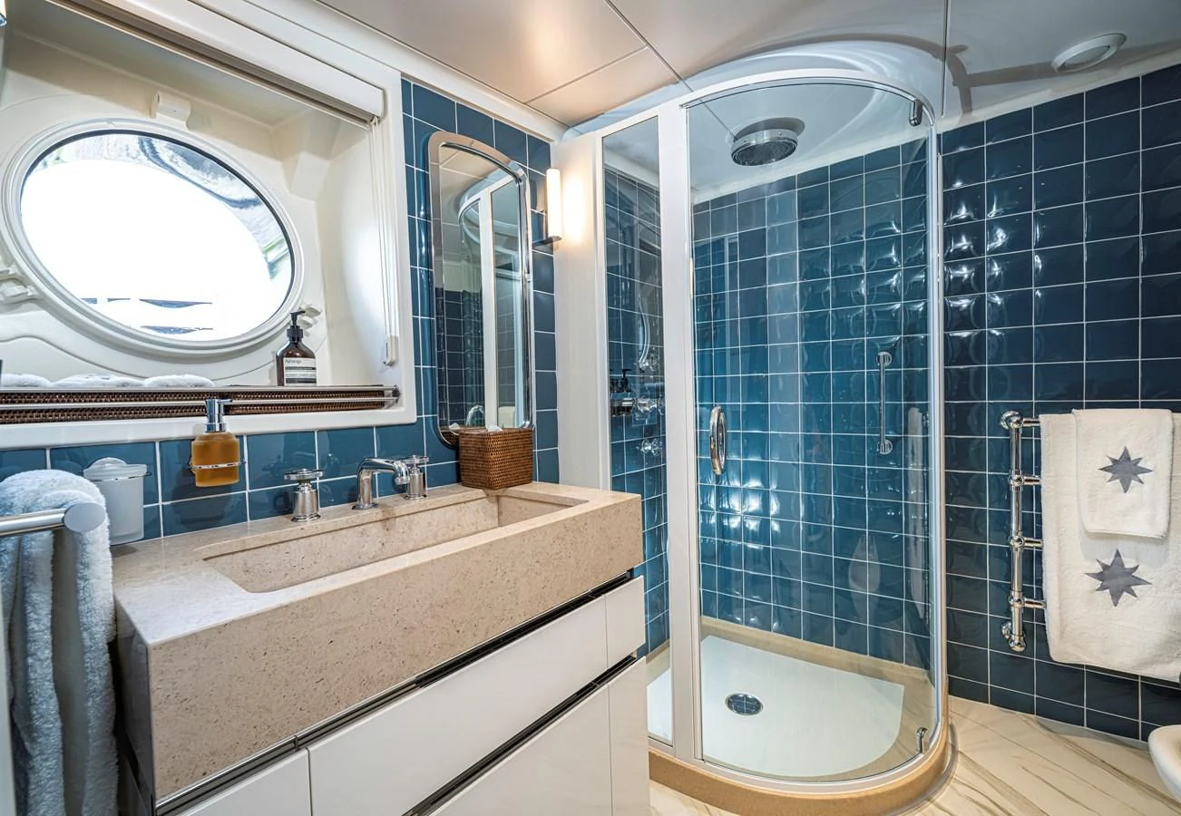a bathroom with a blue shower aboard ASTERIA Yacht for Charter