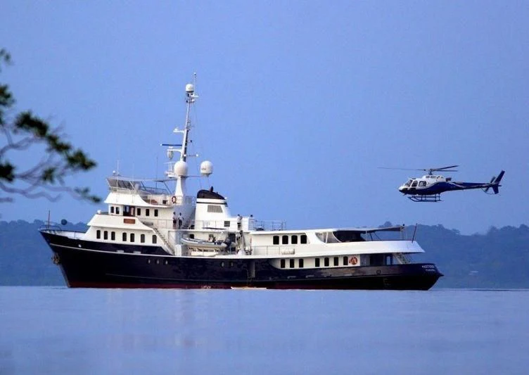 a helicopter flying over a boat aboard ASTERIA Yacht for Charter