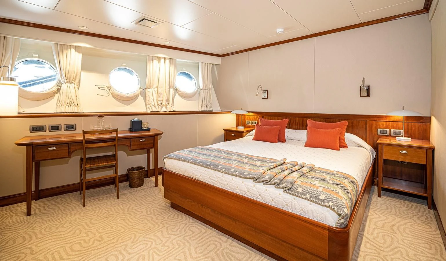 a bedroom with a bed and desk aboard ASTERIA Yacht for Charter