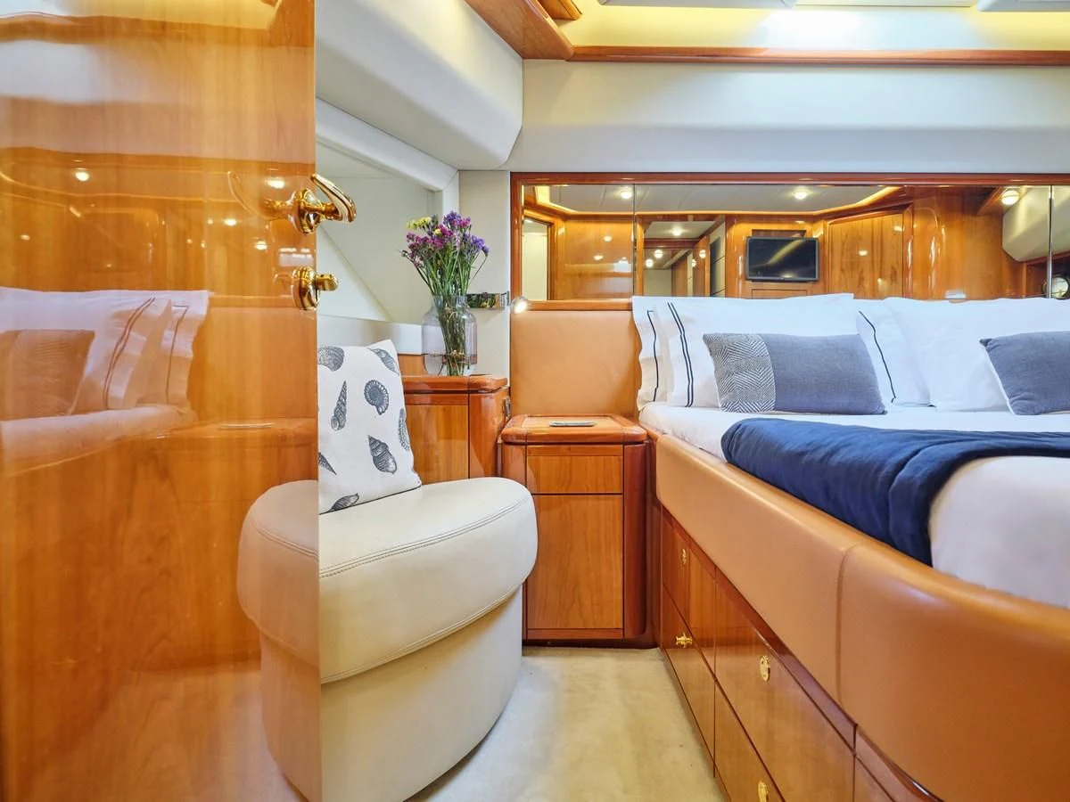 a bedroom with a bed and a chair aboard ESTIA YI Yacht for Sale