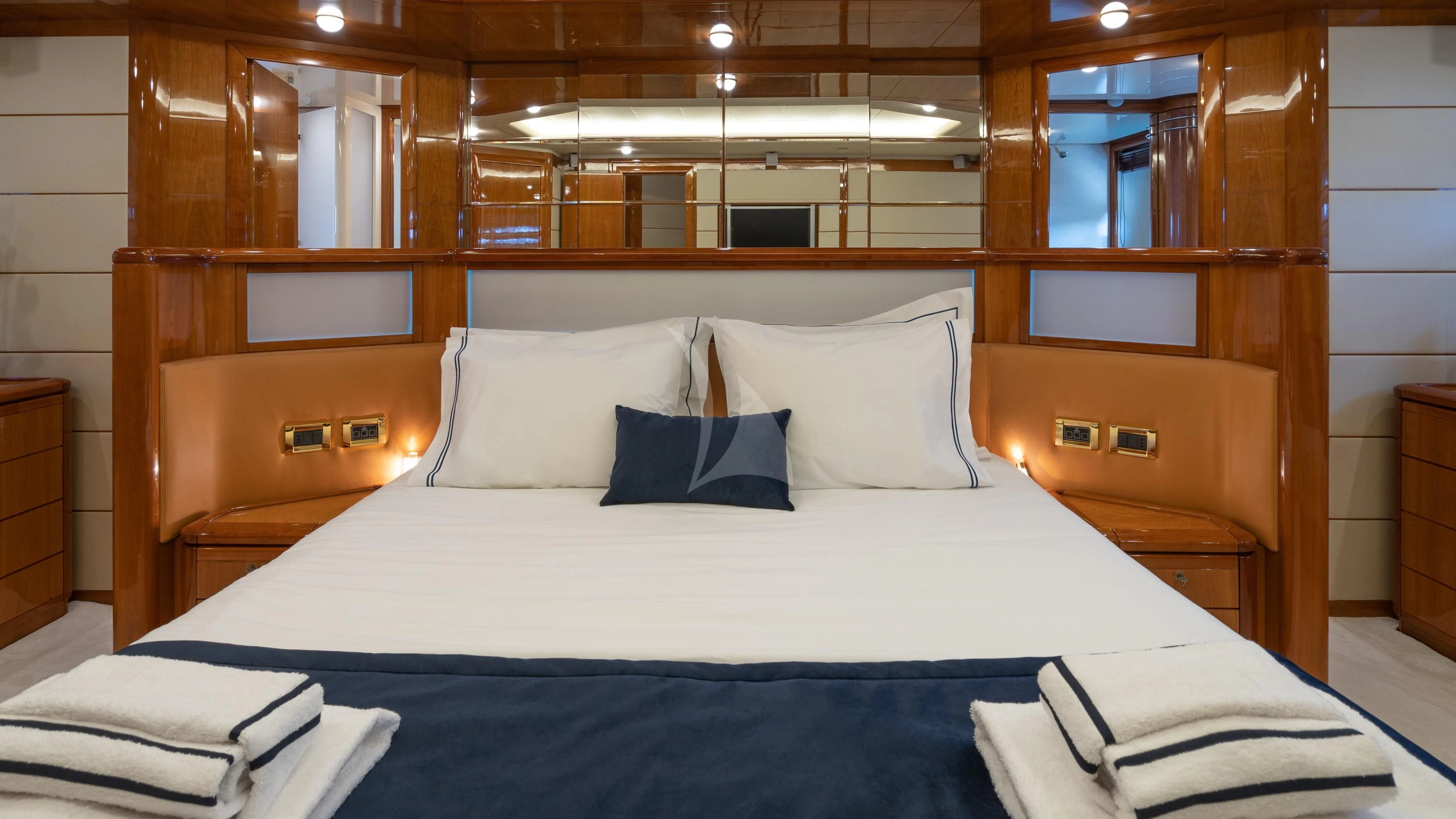 a bed with white sheets and pillows aboard ESTIA YI Yacht for Sale