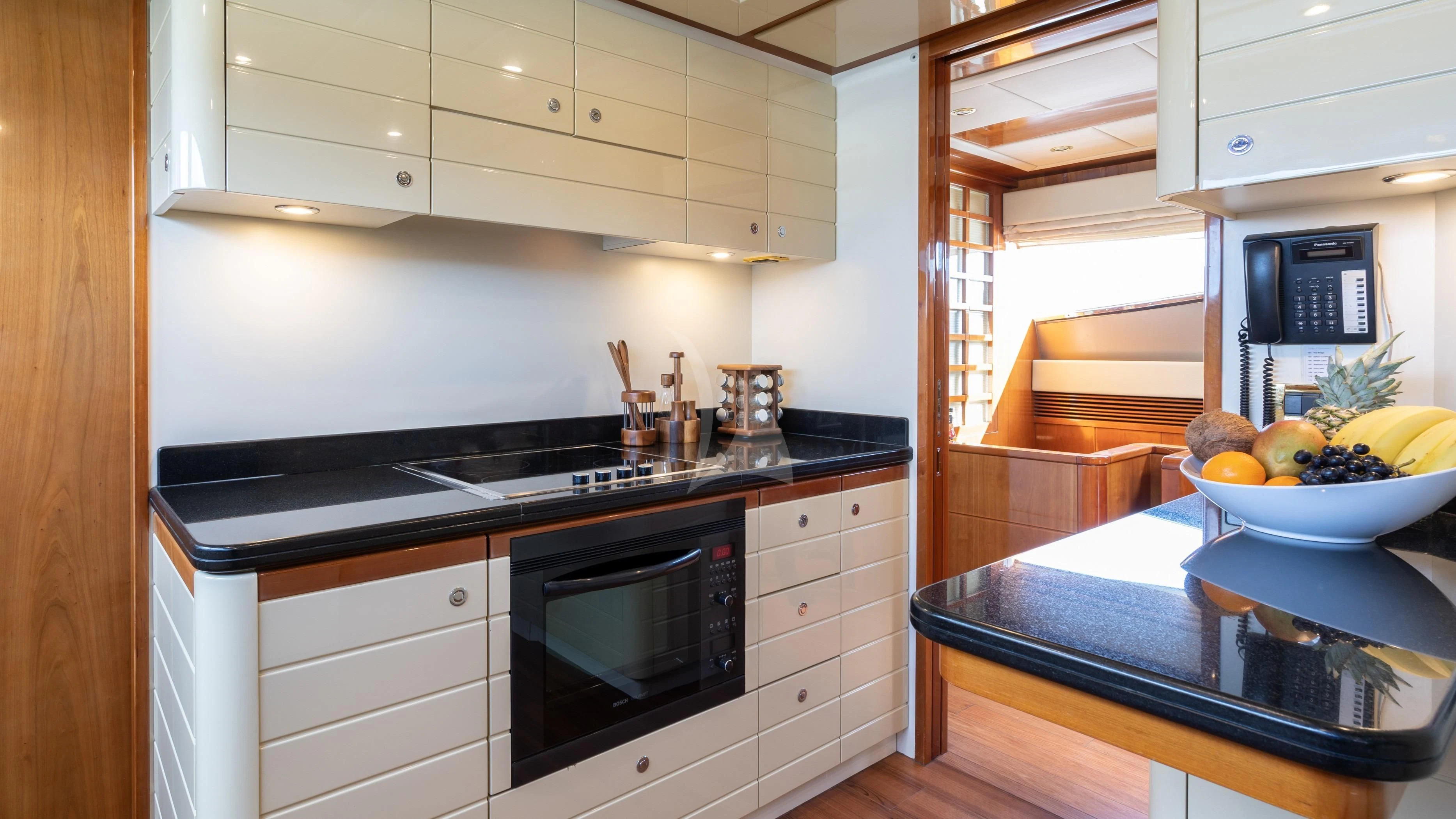 a kitchen with a bowl of fruit aboard ESTIA YI Yacht for Sale