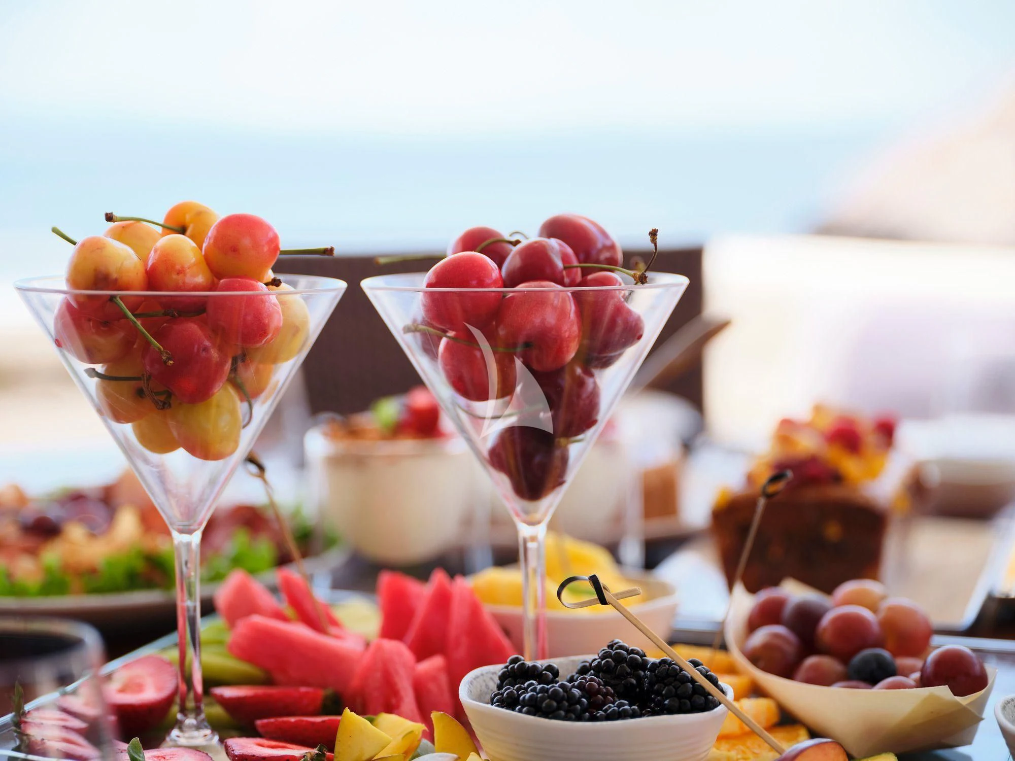 a group of glasses with red liquid and fruit on a table aboard ESTIA YI Yacht for Sale