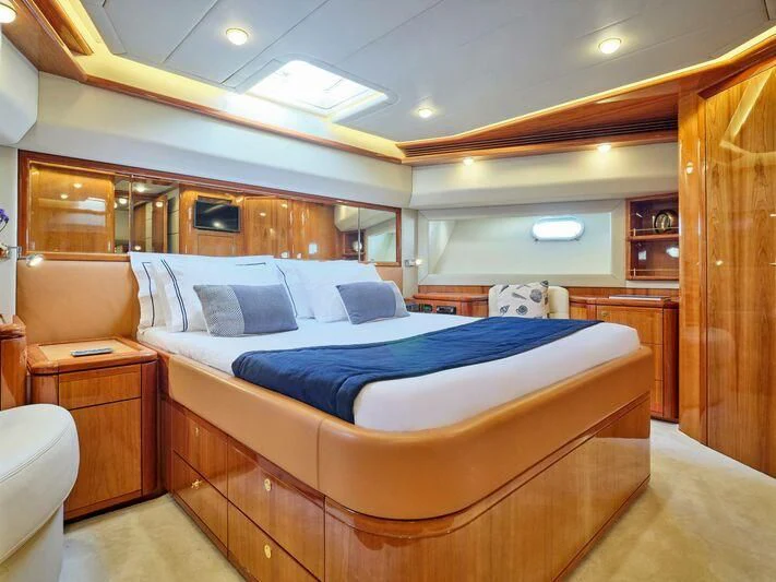 a bedroom with a bed and a desk aboard ESTIA YI Yacht for Sale
