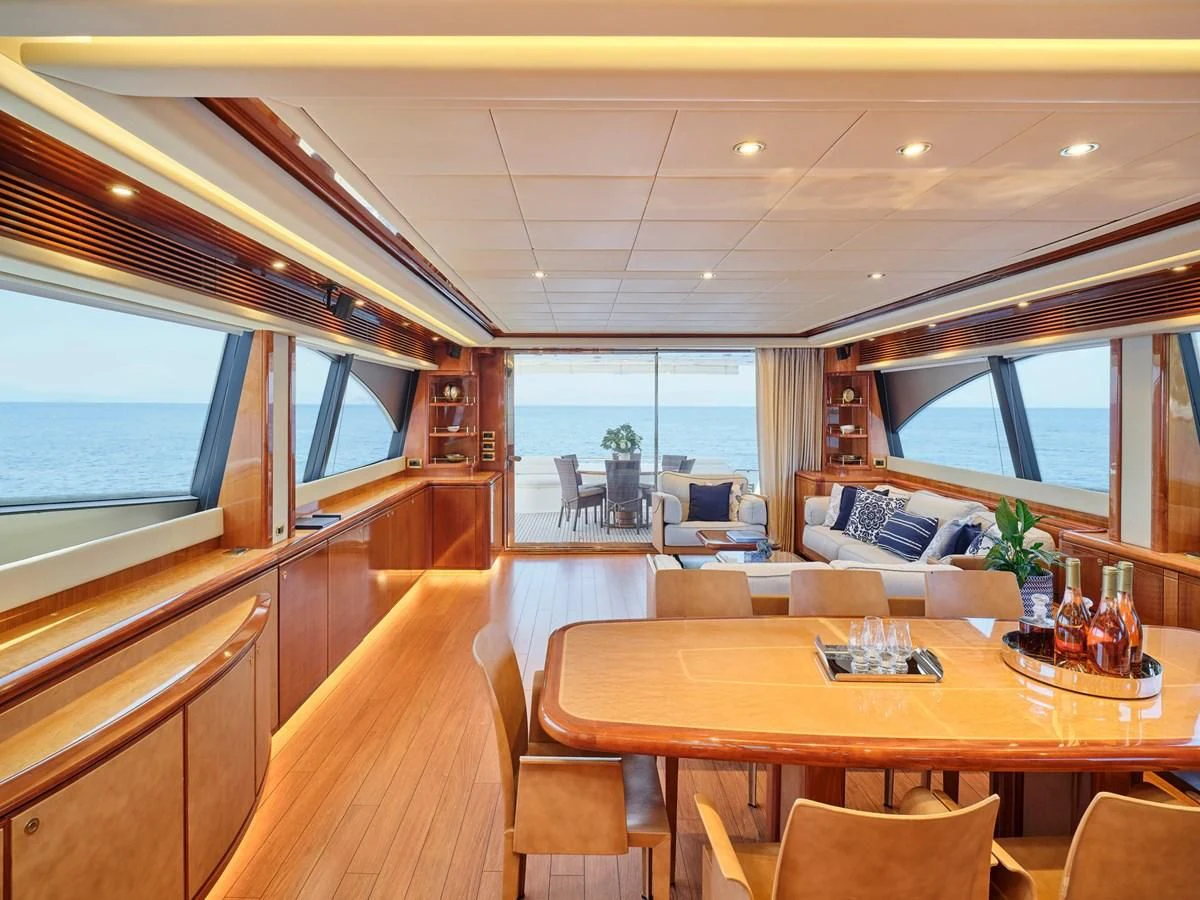 a room with a table chairs and a tv aboard ESTIA YI Yacht for Sale