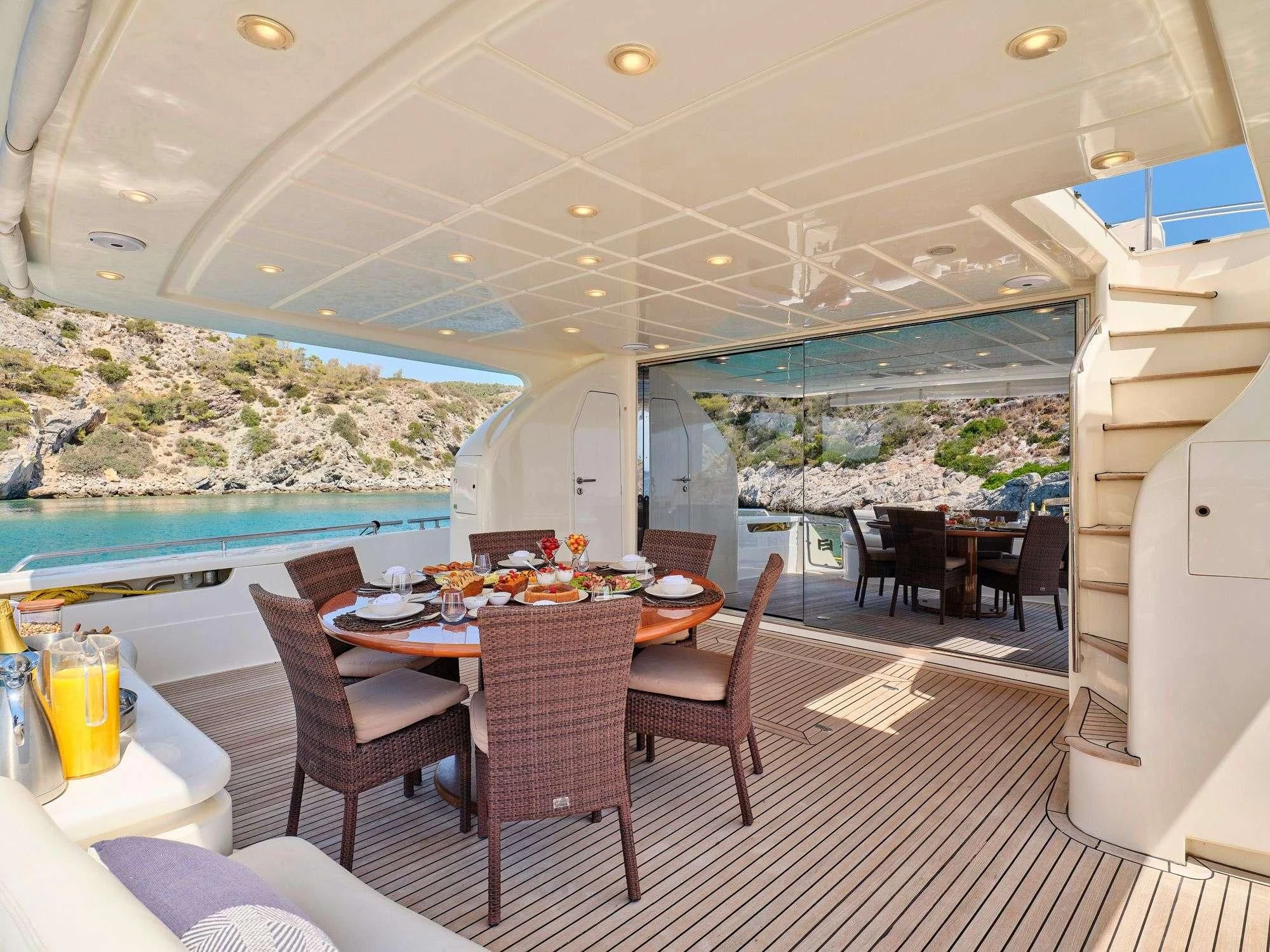 a room with a table chairs and a pool aboard ESTIA YI Yacht for Sale