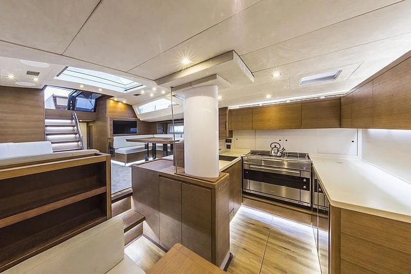 a large kitchen with a large white pillar and a tile floor aboard JIKAN Yacht for Charter