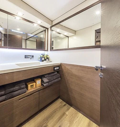 a bathroom with a sink and a mirror aboard JIKAN Yacht for Charter