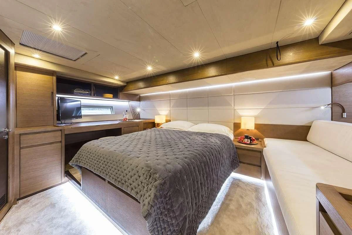 a room with a bed and a couch aboard JIKAN Yacht for Charter