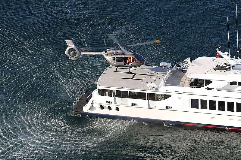a helicopter flying over a boat aboard TANGO Yacht for Sale