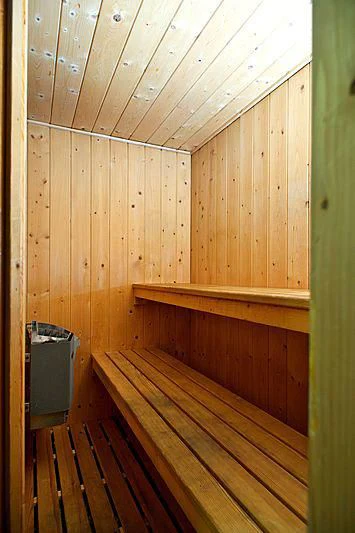 a wooden room with a metal trash can and wood walls aboard TANGO Yacht for Sale