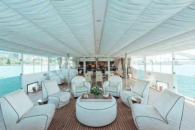 a large living room with a large table and chairs aboard TANGO Yacht for Sale