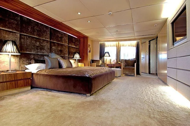 a large bedroom with a large bed aboard TANGO Yacht for Sale