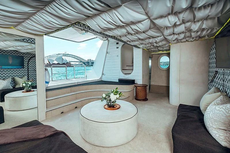 a room with a table and a couch aboard TANGO Yacht for Sale