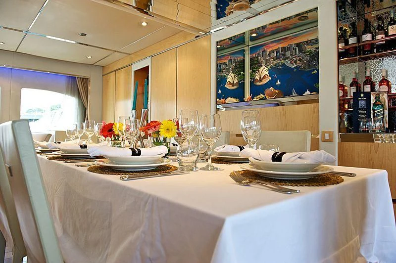 a table with plates and glasses aboard TANGO Yacht for Sale