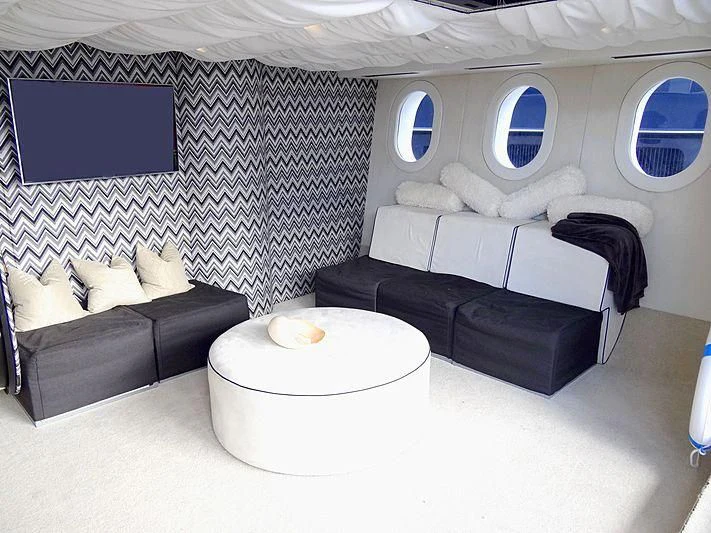 a room with a couch and a table aboard TANGO Yacht for Sale