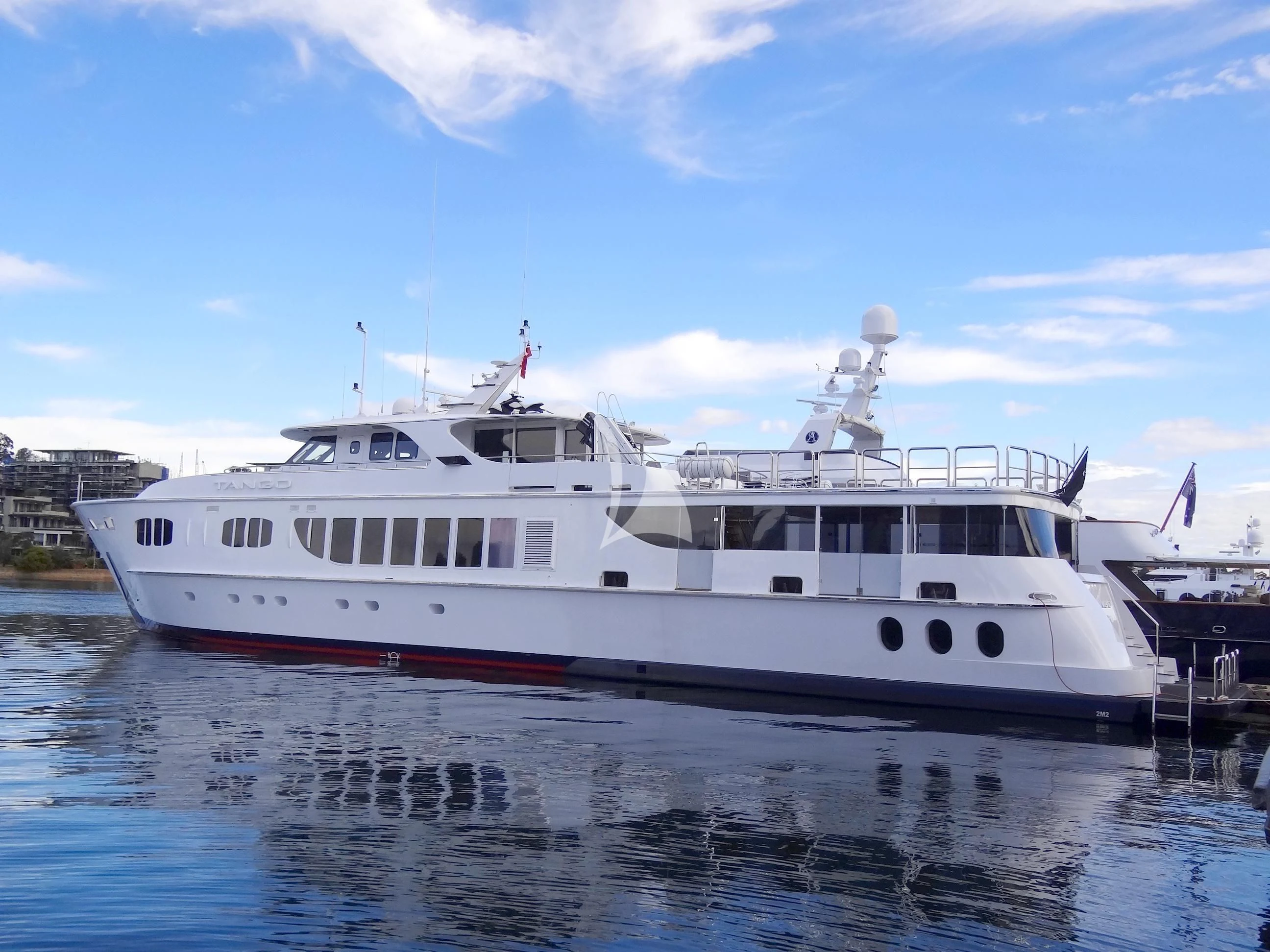 a large white boat in the water aboard TANGO Yacht for Sale