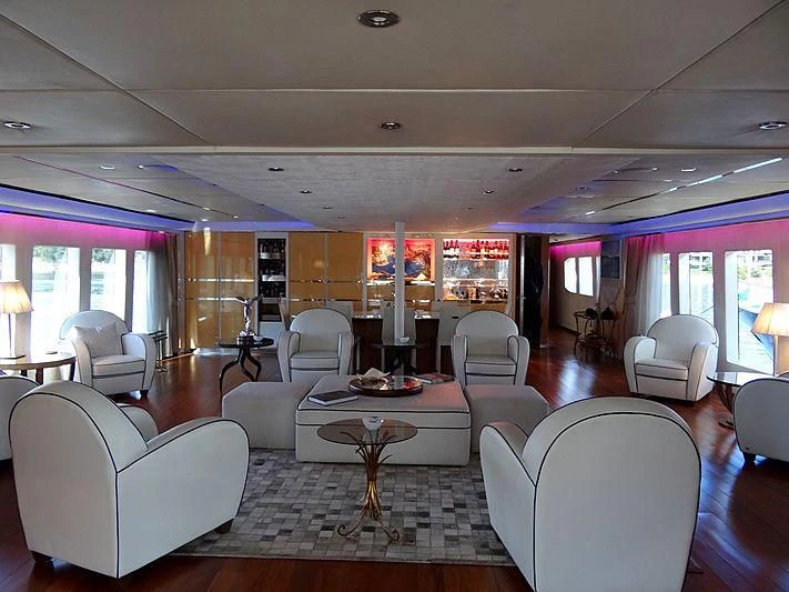 a living room with a table and chairs aboard TANGO Yacht for Sale