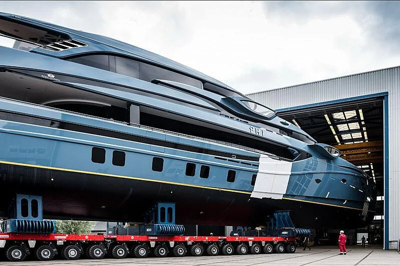 a large airplane is parked outside of a building aboard PHI Yacht for Sale