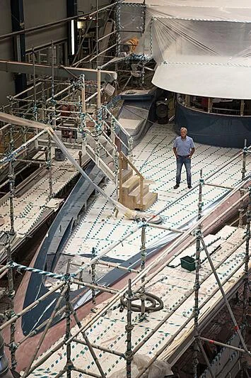 a person standing on a large structure aboard PHI Yacht for Sale