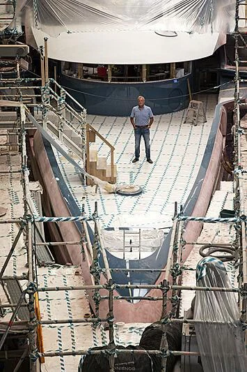 a person standing on a ladder in a factory aboard PHI Yacht for Sale