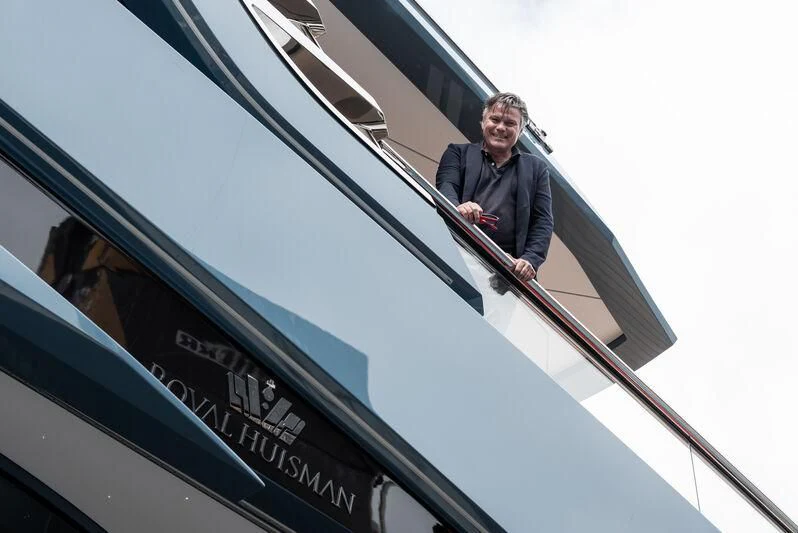a man standing on the top of a building aboard PHI Yacht for Sale