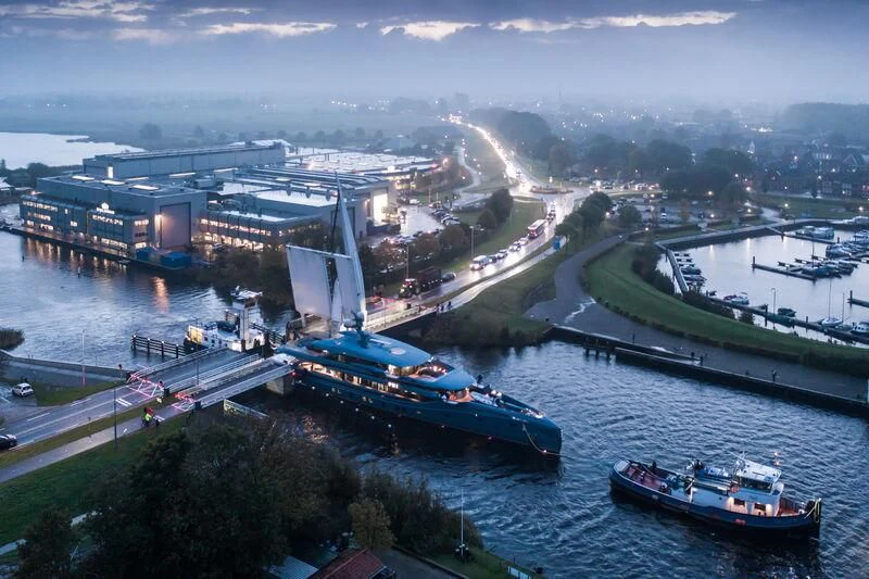 a river with boats and buildings along it aboard PHI Yacht for Sale