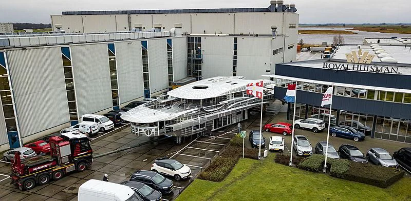 a large building with cars parked in front of it aboard PHI Yacht for Sale
