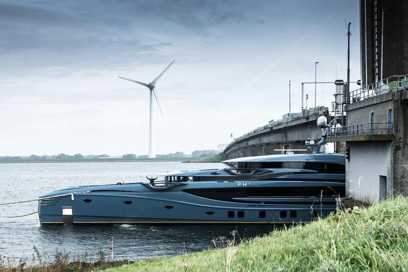a boat is parked on the side of a river aboard PHI Yacht for Sale