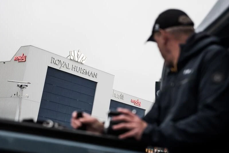 a man holding a tablet aboard PHI Yacht for Sale