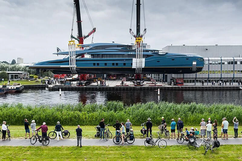 a group of people on bicycles by a large ship aboard PHI Yacht for Sale