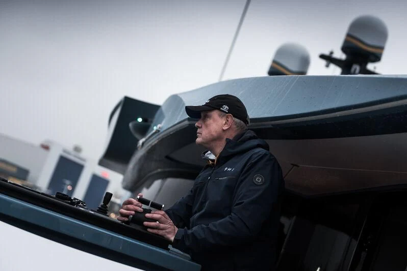 a man in a military uniform aboard PHI Yacht for Sale