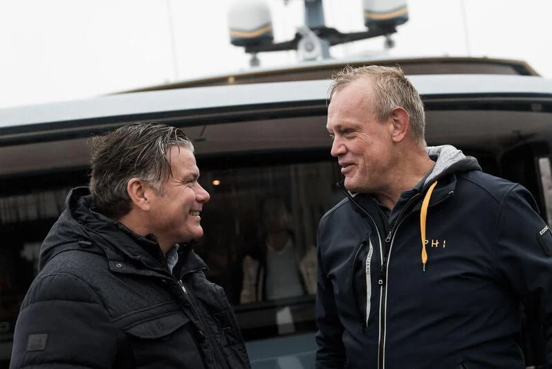 a couple of men talking aboard PHI Yacht for Sale