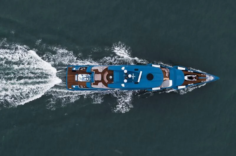 a blue and red boat in the water aboard PHI Yacht for Sale