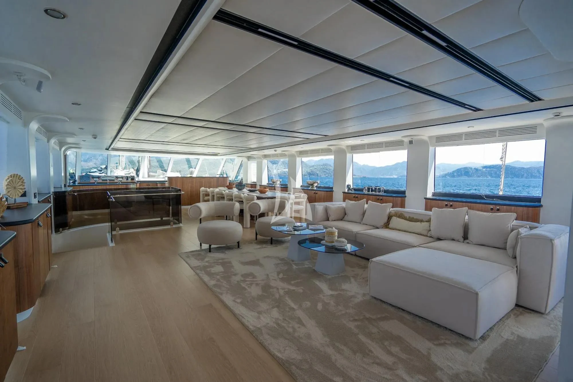 a large living room with a large window aboard DE LOVE Yacht for Charter
