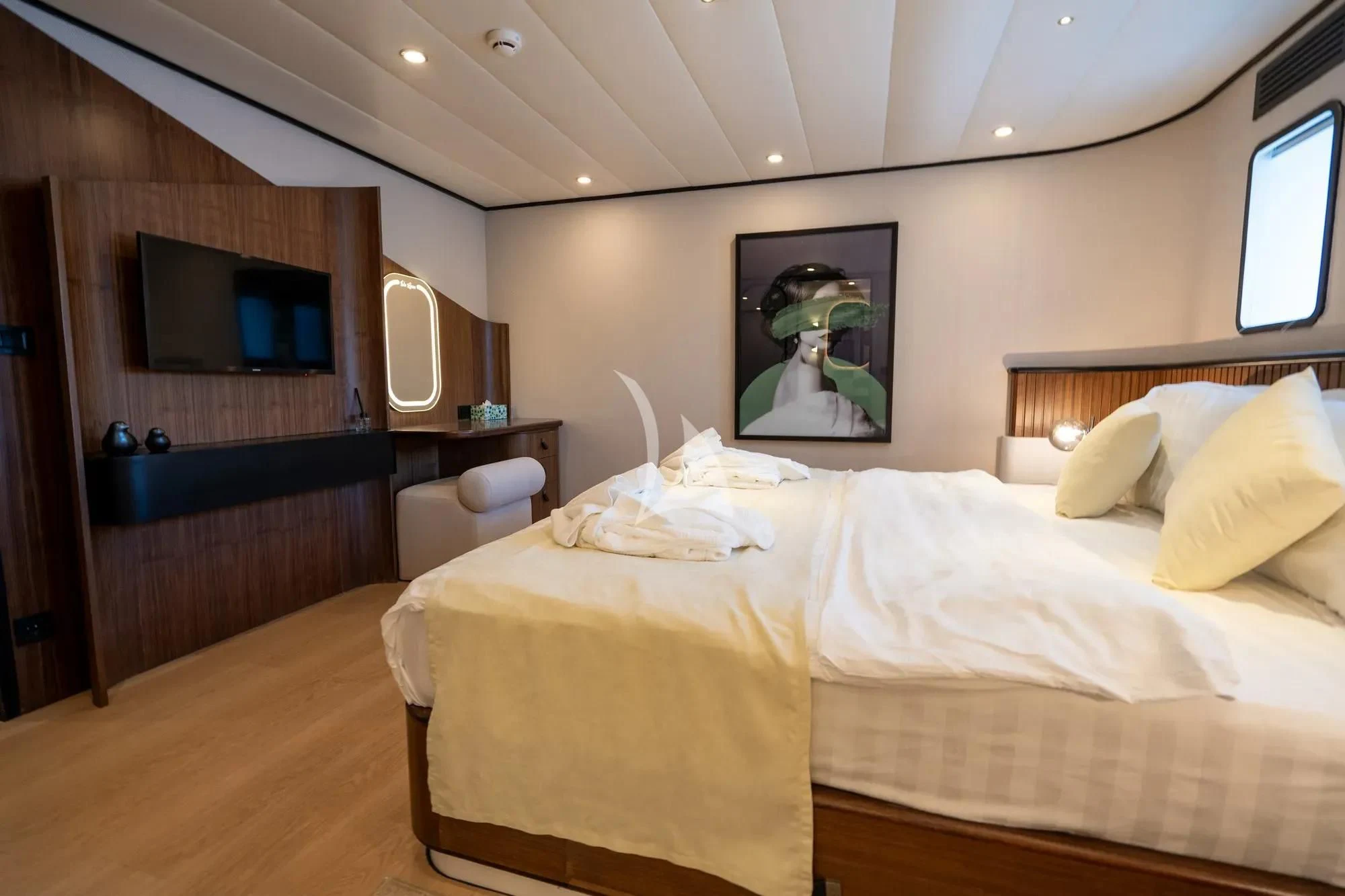 a bedroom with a bed and a television on the wall aboard DE LOVE Yacht for Charter