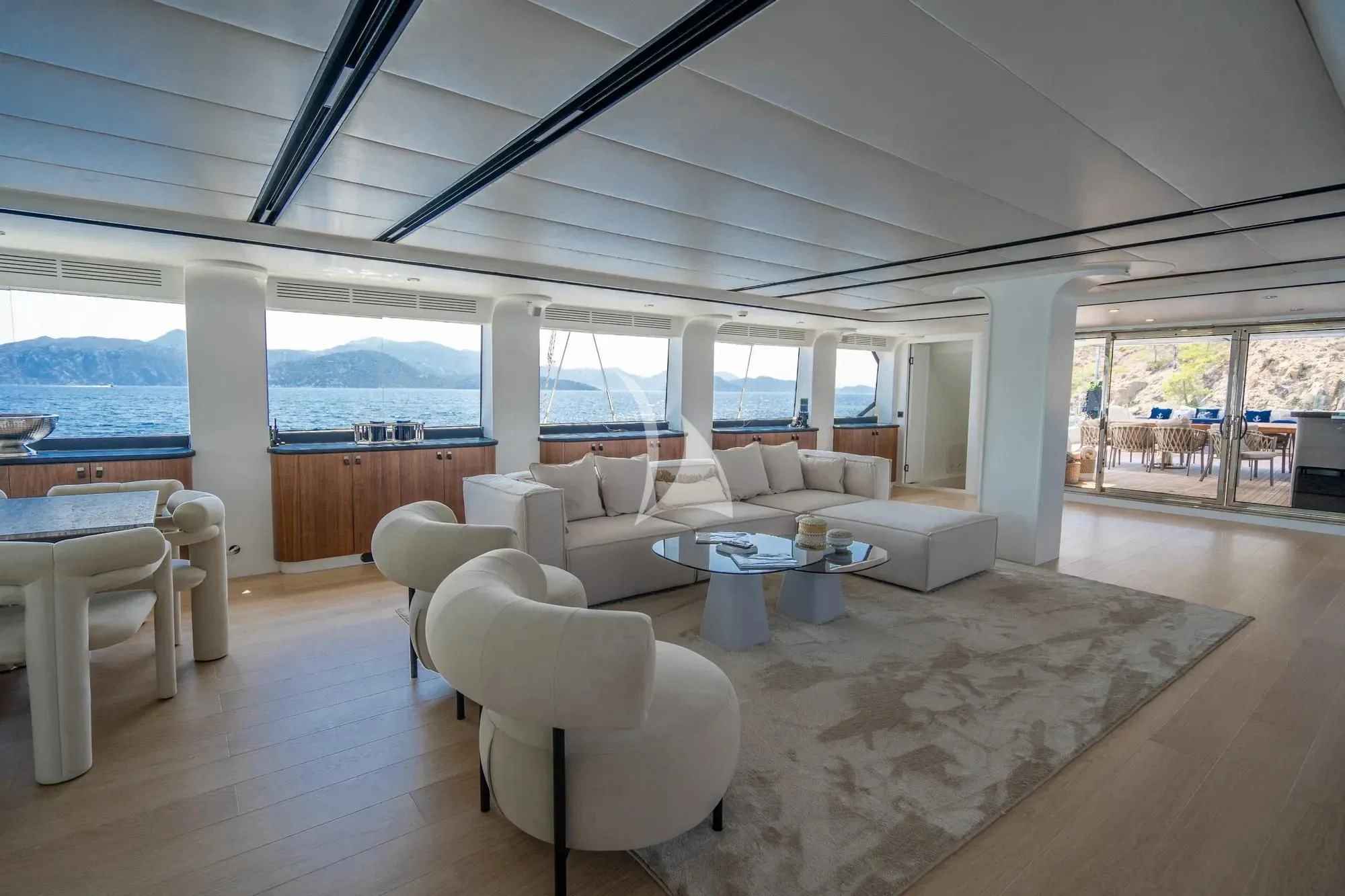 a room with a large white sofa and a large window aboard DE LOVE Yacht for Charter