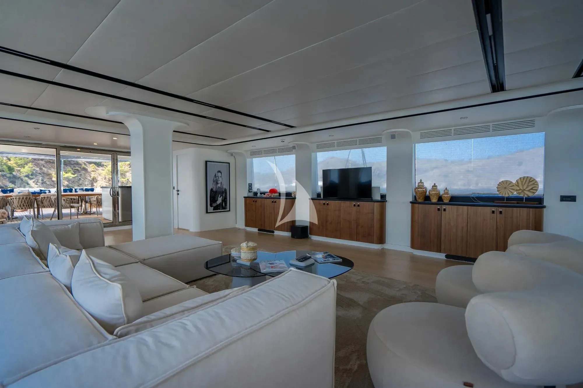 a living room with white furniture aboard DE LOVE Yacht for Charter