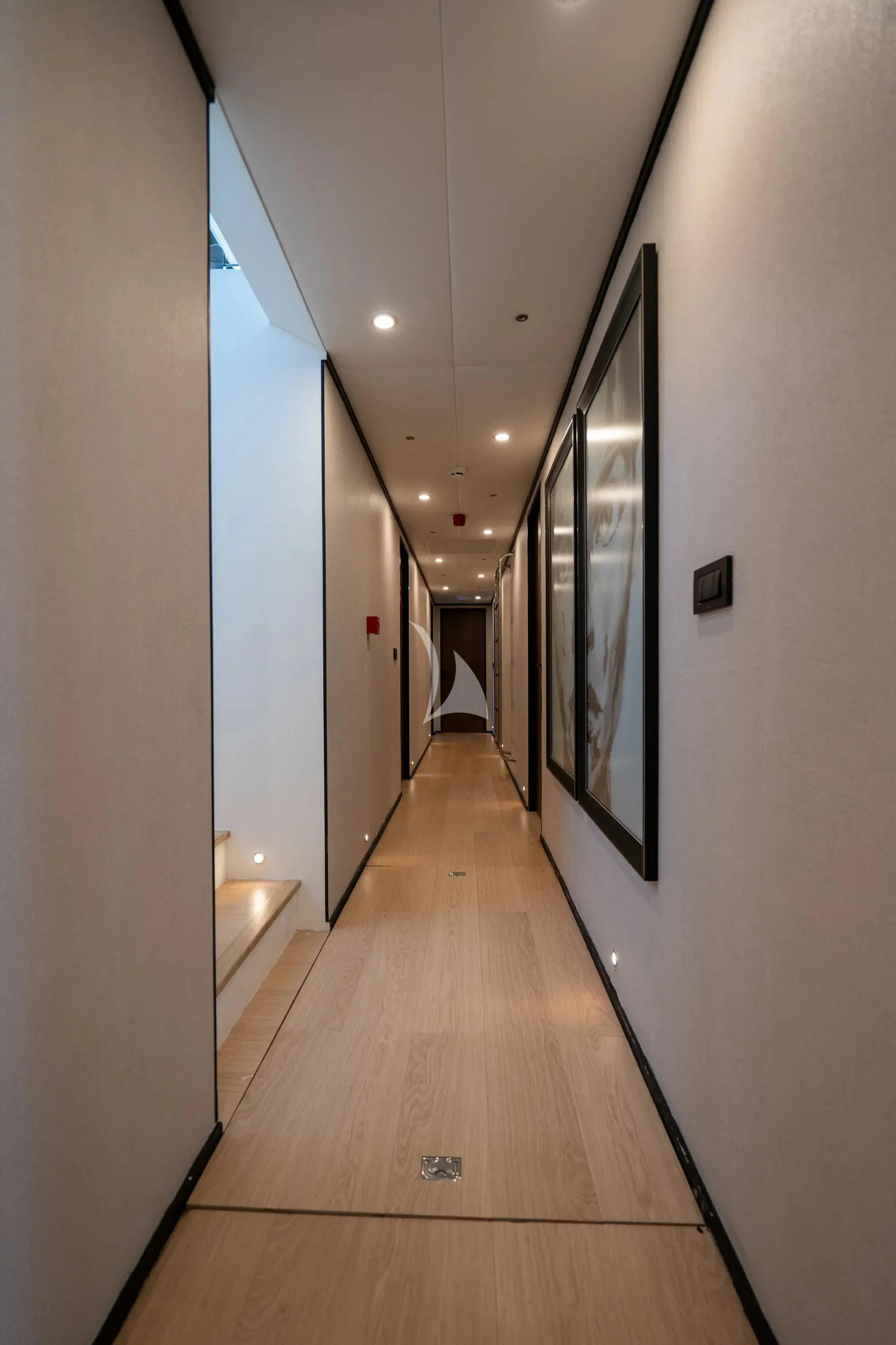 a hallway with a wood floor and a painting on the wall aboard DE LOVE Yacht for Charter